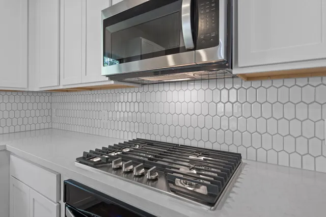 a stove top oven sitting inside of a kitchen