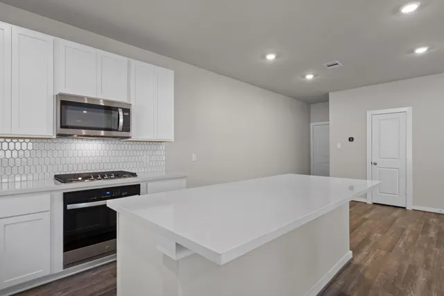 a view of a kitchen with electric appliances