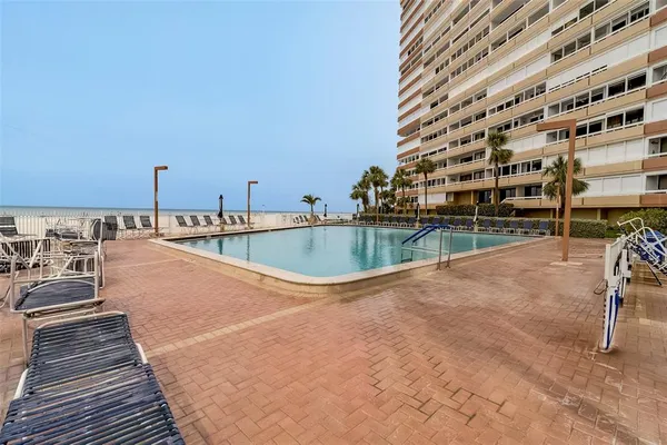 a view of a swimming pool with a yard