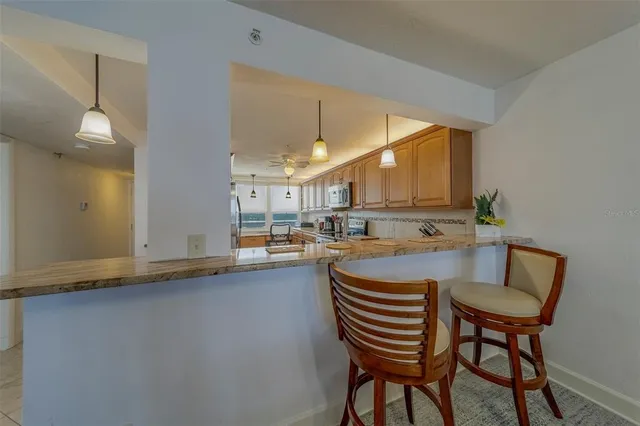 a kitchen with a table chairs and a refrigerator