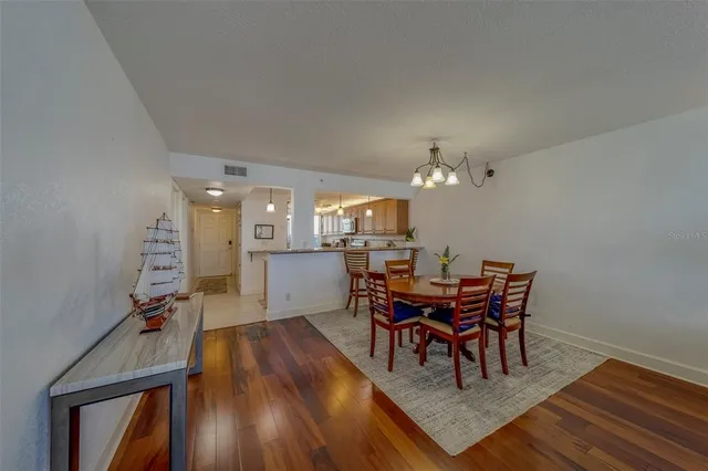 a view of a dining room with furniture and chandelier