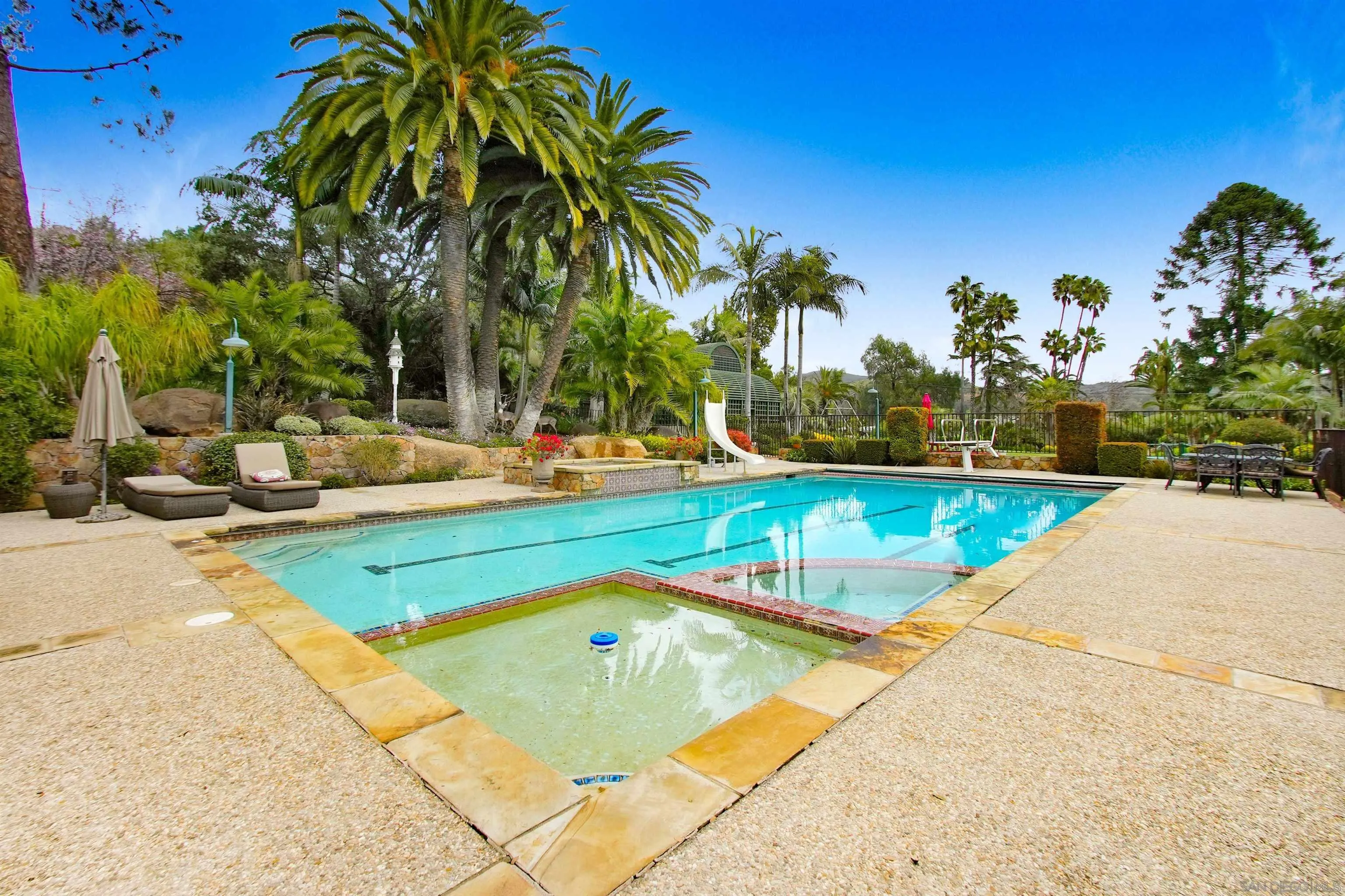 16757 Old Guejito Grade Road Escondido, CA 92027 - Photo 12 of 49 a view of swimming pool with outdoor seating and house in the background