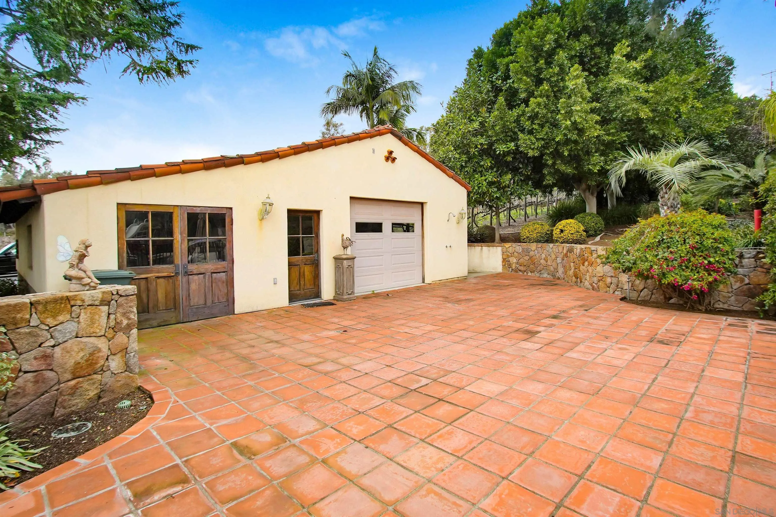 16757 Old Guejito Grade Road Escondido, CA 92027 - Photo 18 of 49 a view of a house with a yard and potted plants