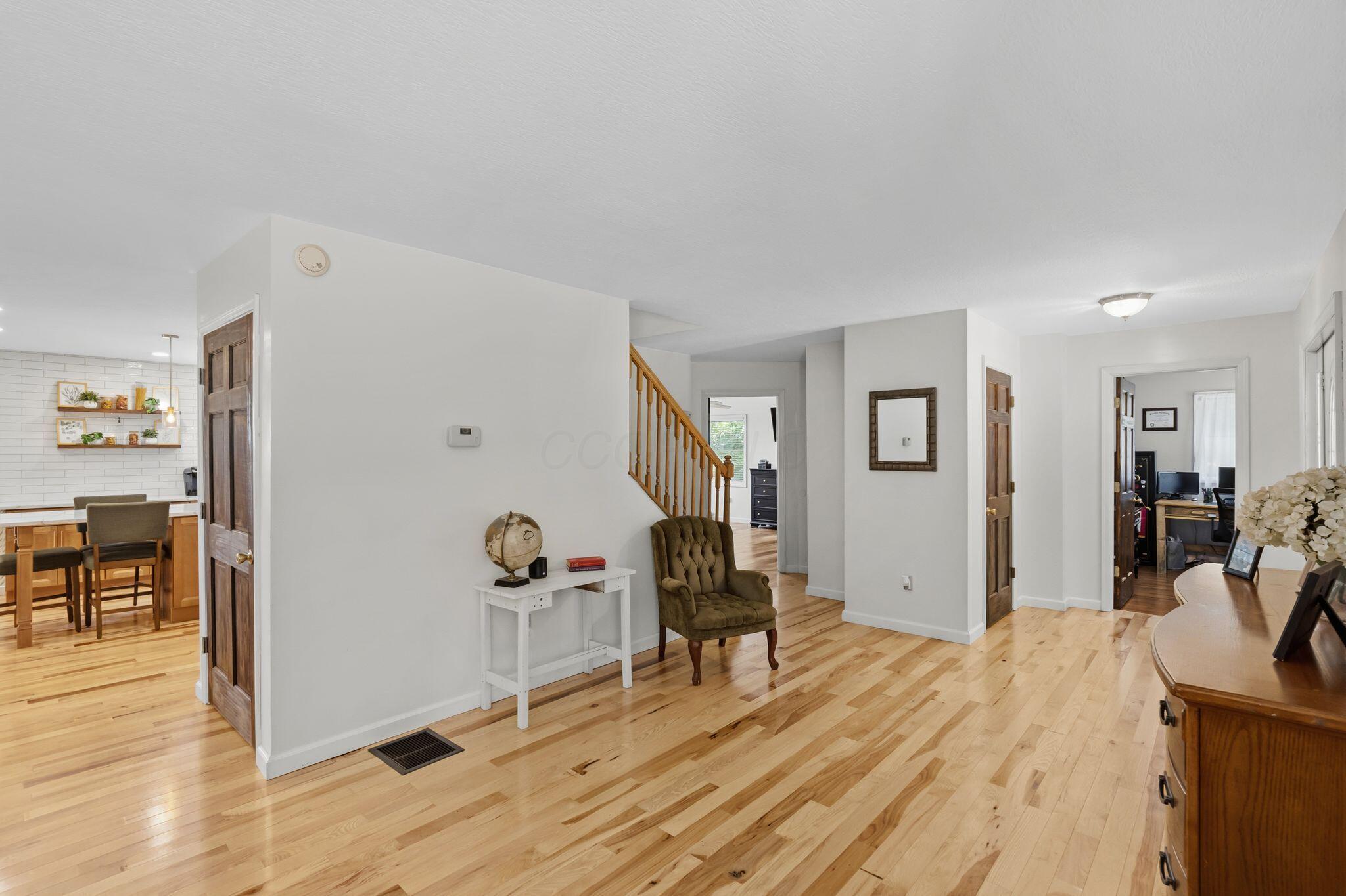 10446 Rich Hollow Road Southwest Lancaster, OH 43130 - Photo 39 of 83 Light-toned wood-finish flooring extends throughout this interior, featuring white walls and dark wood doors