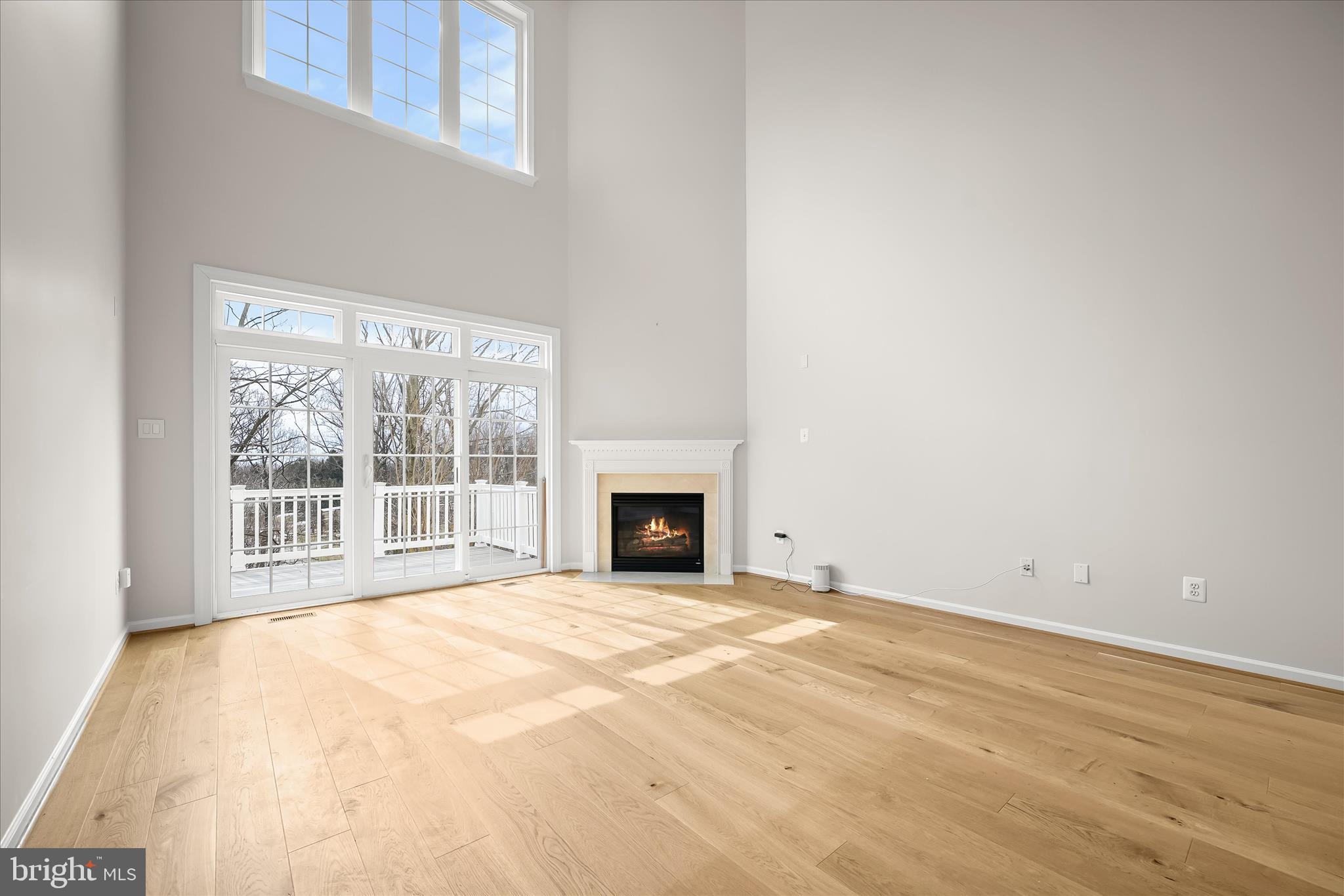 8736 Endless Ocean Way, Unit 24 Columbia, MD 21045 - Photo 13 of 61 a view of an empty room with a fireplace and a window