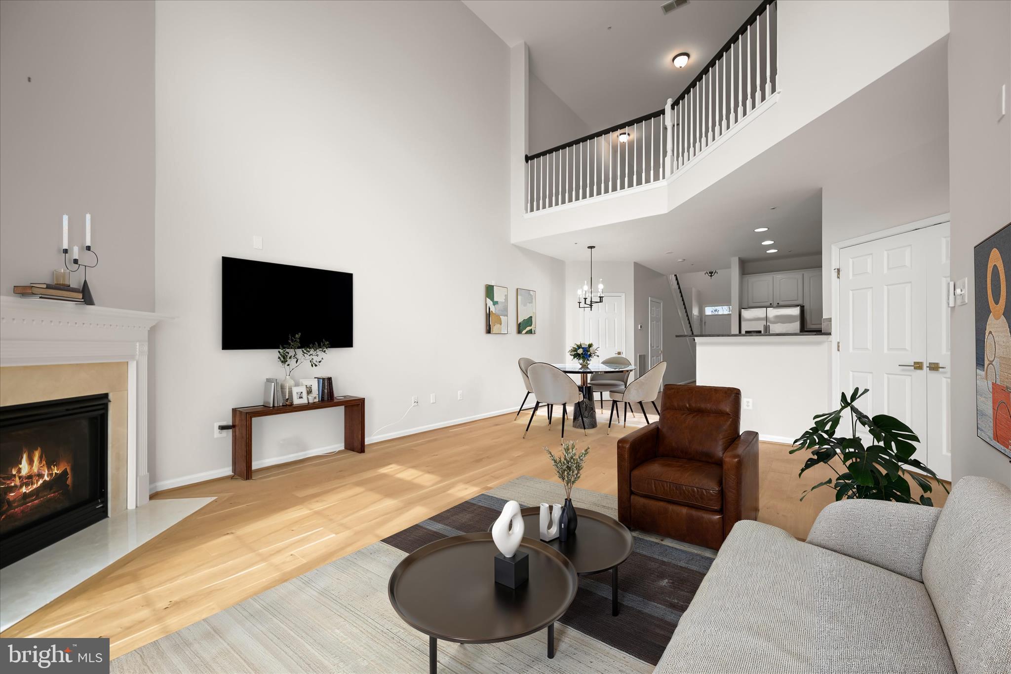 8736 Endless Ocean Way, Unit 24 Columbia, MD 21045 - Photo 14 of 61 a living room with furniture and a flat screen tv