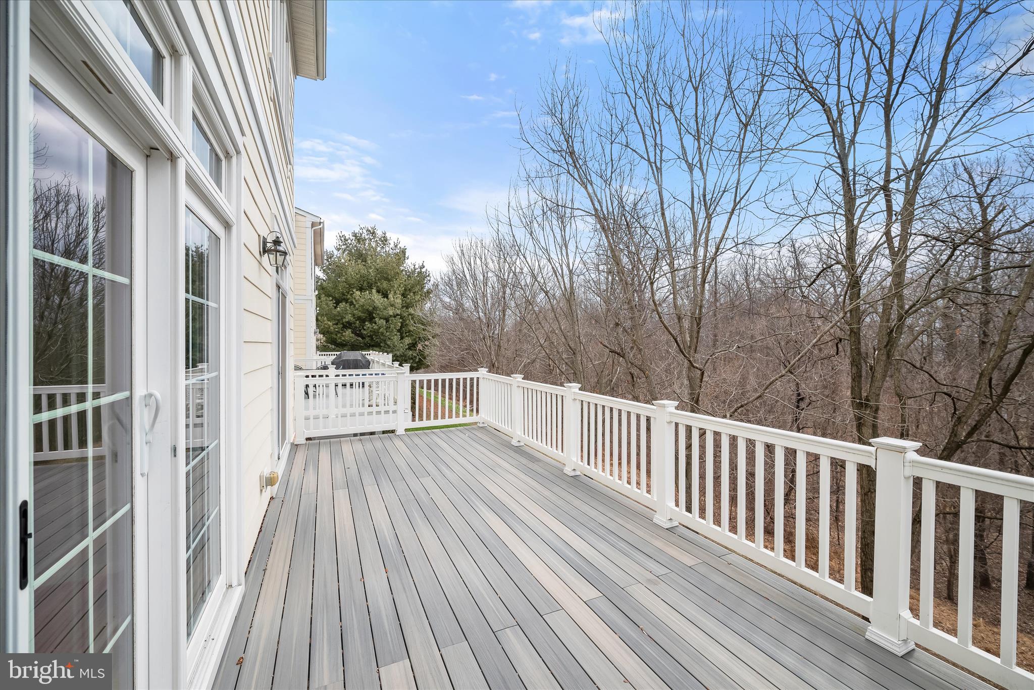 8736 Endless Ocean Way, Unit 24 Columbia, MD 21045 - Photo 19 of 61 a view of a wooden balcony and trees
