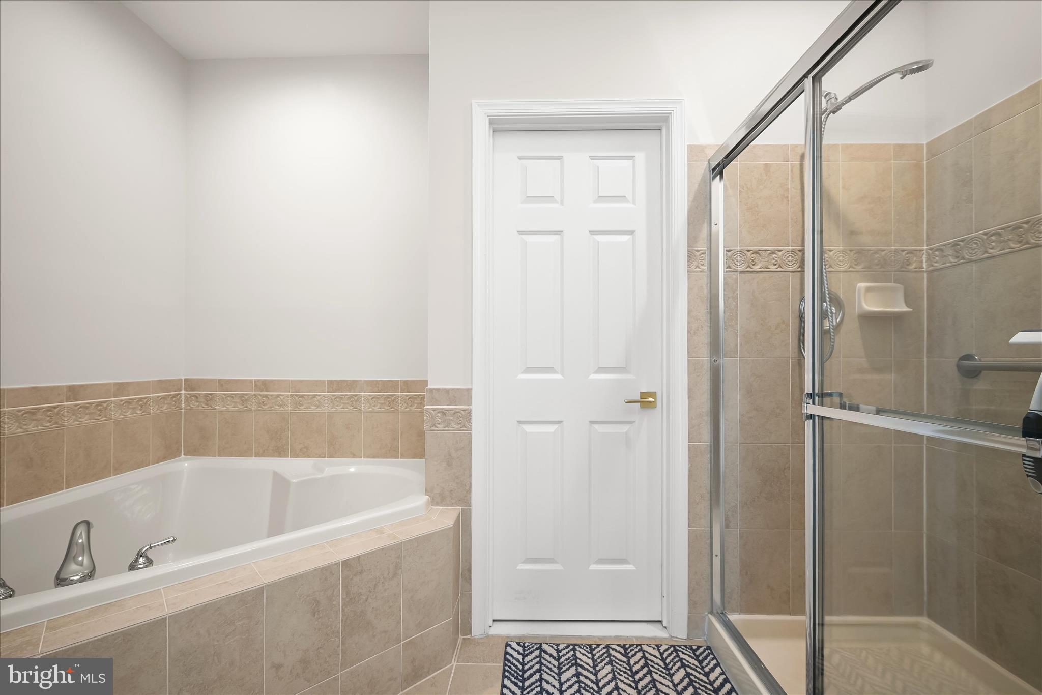 8736 Endless Ocean Way, Unit 24 Columbia, MD 21045 - Photo 24 of 61 a bathroom with a bathtub and shower