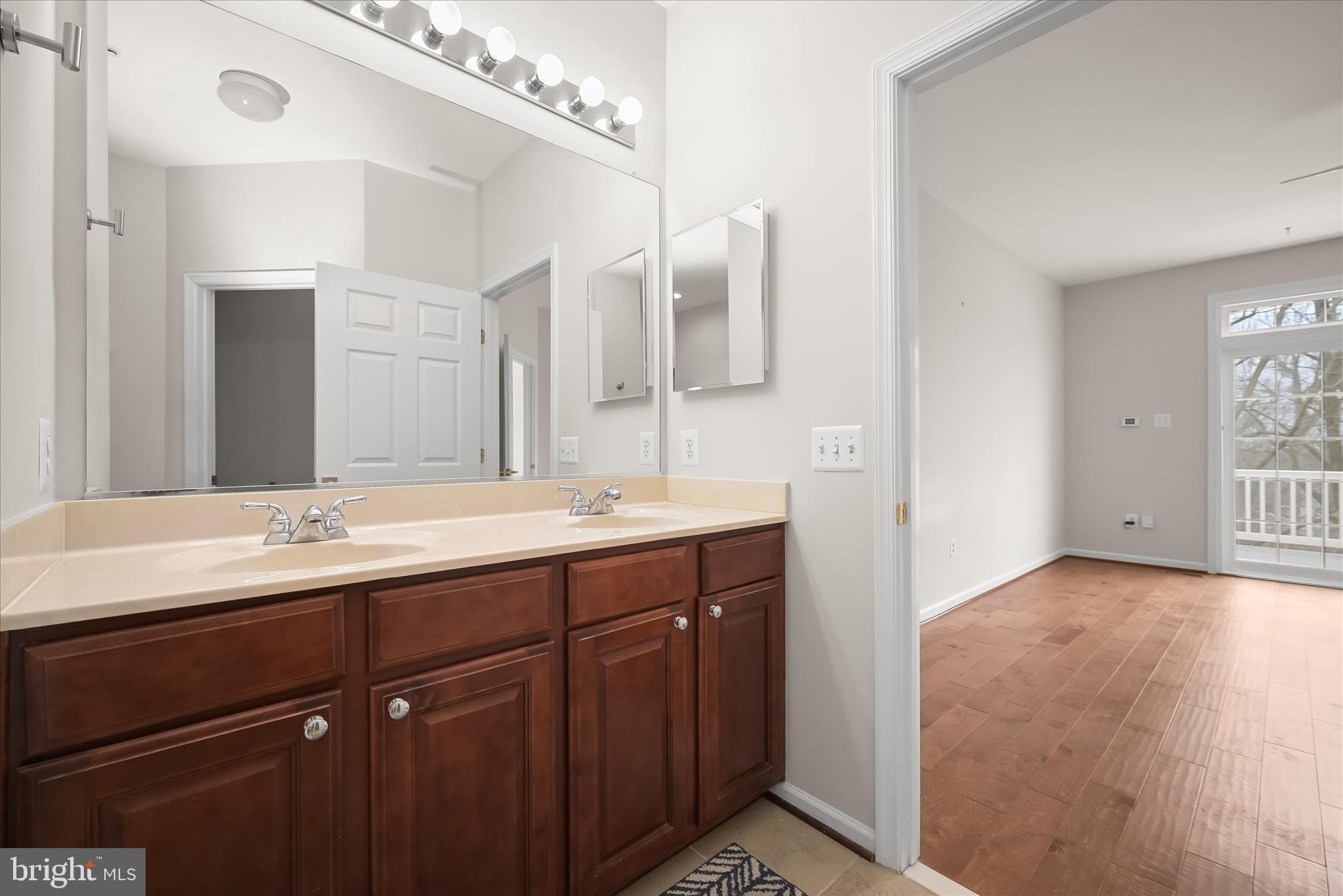 8736 Endless Ocean Way, Unit 24 Columbia, MD 21045 - Photo 27 of 61 a bathroom with a double vanity sink and a mirror