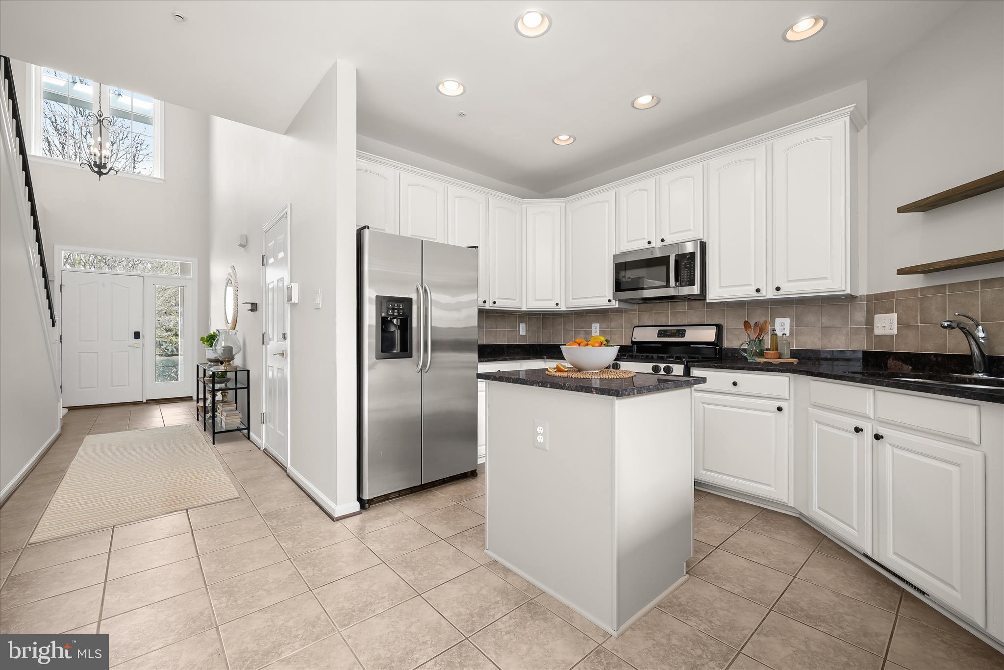 8736 Endless Ocean Way, Unit 24 Columbia, MD 21045 - Photo 6 of 61 a kitchen with stainless steel appliances granite countertop a refrigerator and a stove top oven