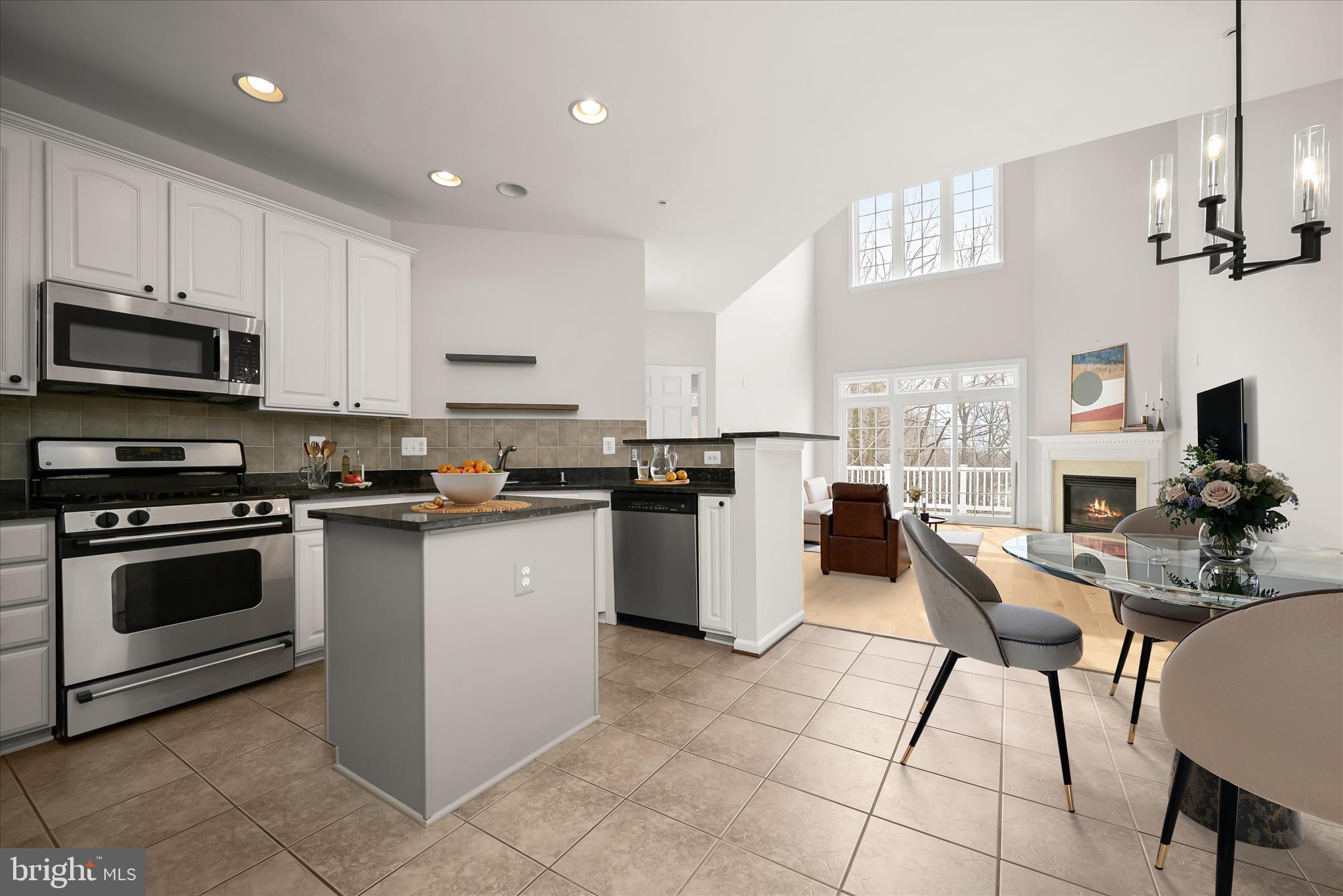 8736 Endless Ocean Way, Unit 24 Columbia, MD 21045 - Photo 7 of 61 a kitchen with a sink a counter top space and stainless steel appliances