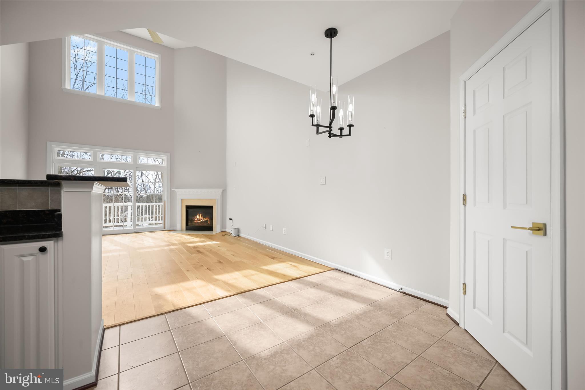 8736 Endless Ocean Way, Unit 24 Columbia, MD 21045 - Photo 10 of 61 a view of an empty room with kitchen and window