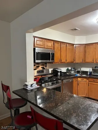 a kitchen with a stove a sink and a microwave