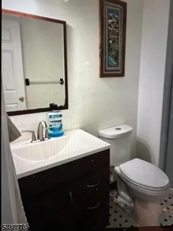 a bathroom with a sink a toilet and mirror