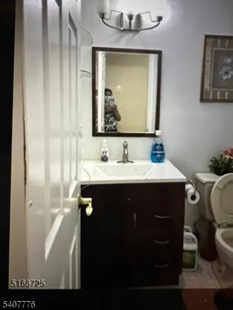 a bathroom with a sink vanity and a mirror