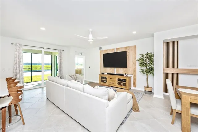 a living room with lots of furniture and kitchen view