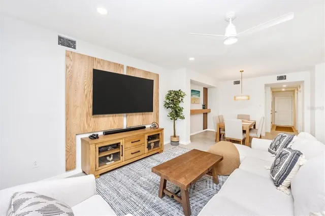 a spacious bedroom with a bed and a flat screen tv