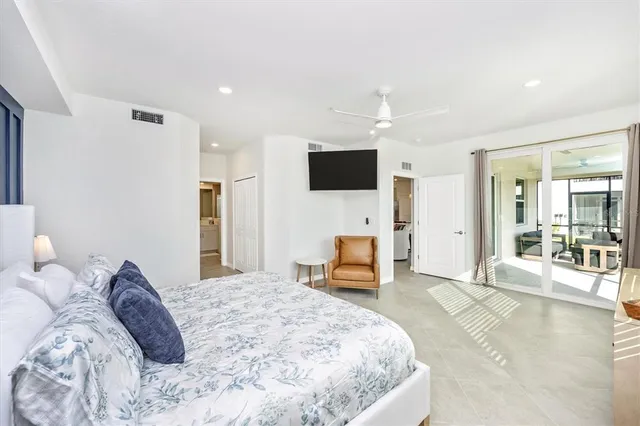 a bedroom with a bed and painting on the wall