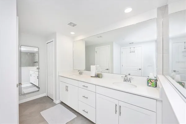 a bathroom with a bathtub shower sink vanity and toilet