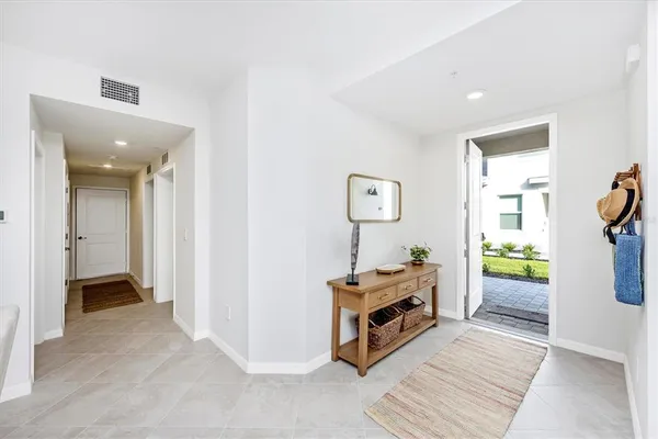 a kitchen with stainless steel appliances kitchen island granite countertop a refrigerator and microwave