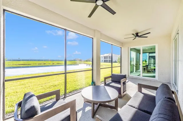 a swimming pool view with a seating space and a garden view