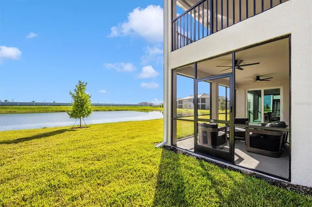 a front view of a house with glass windows and furniture