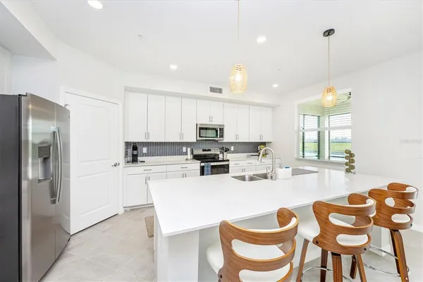 a living room with furniture a flat screen tv and a large window