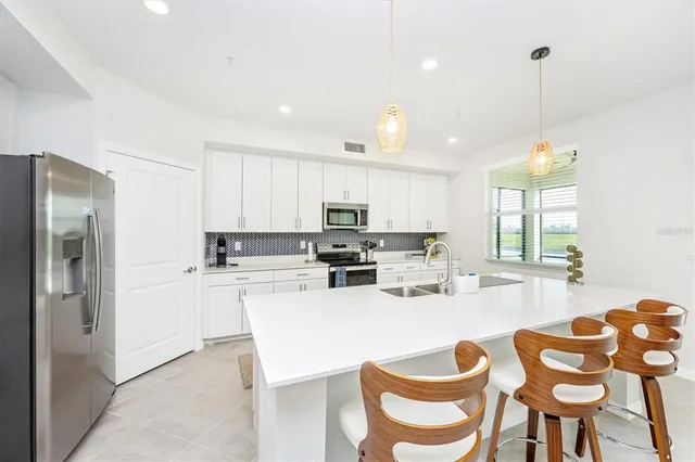 a living room with furniture a flat screen tv and a large window