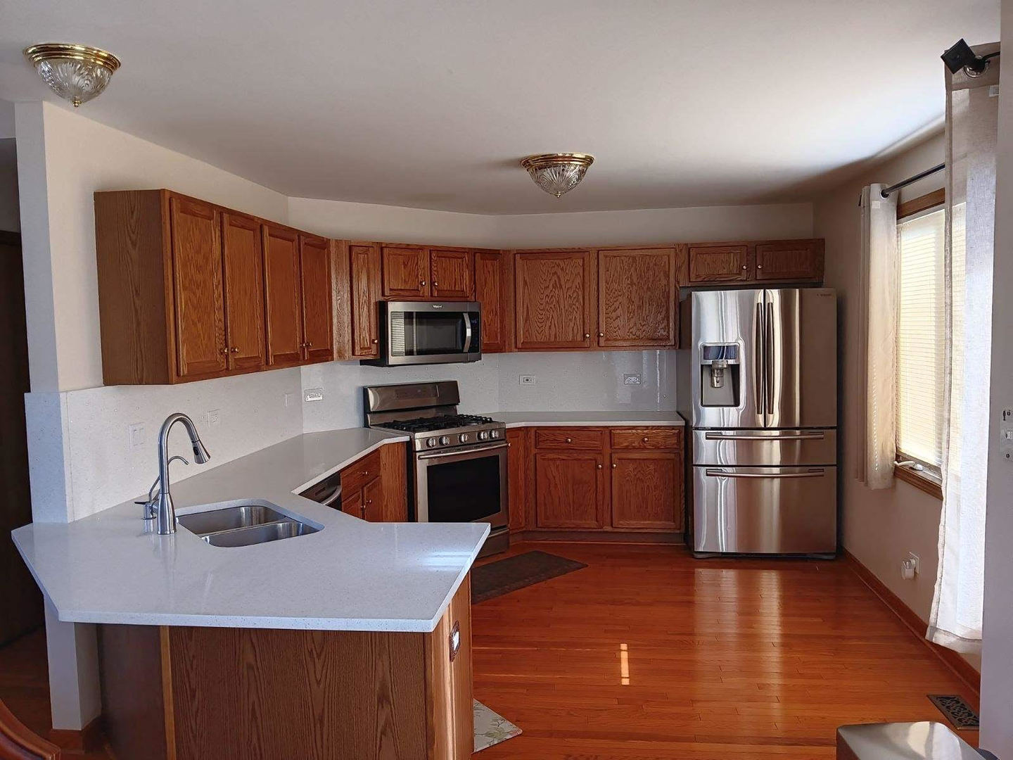 1560 Mallards Cove Beecher, IL 60401 - Photo 11 of 43 a kitchen with kitchen island a sink appliances and cabinets