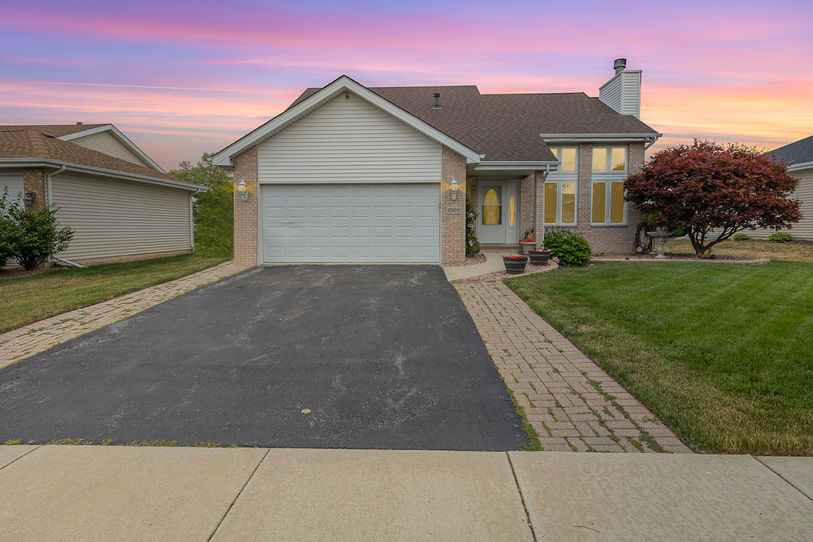 1560 Mallards Cove Beecher, IL 60401 - Photo 2 of 43 a front view of a house with a yard and garage