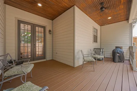 a balcony with furniture and wooden floor