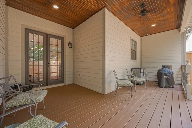 a balcony with furniture and wooden floor