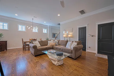 a living room with furniture and a wooden floor