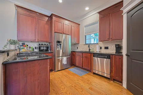a kitchen with stainless steel appliances granite countertop a refrigerator sink and cabinets