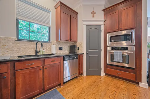 a kitchen with stainless steel appliances granite countertop a refrigerator sink and microwave