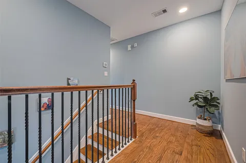 a view of a hallway with wooden floor