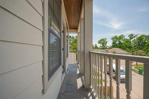 a view of balcony with wooden floor