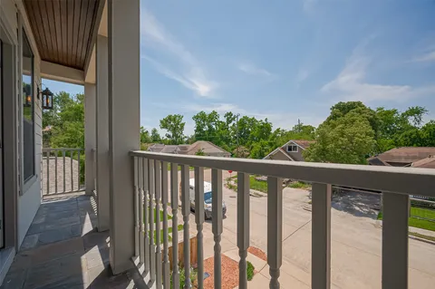 a view of a balcony with wooden floor