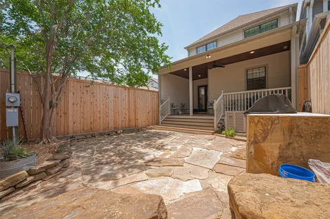 a backyard of a house with table and chairs