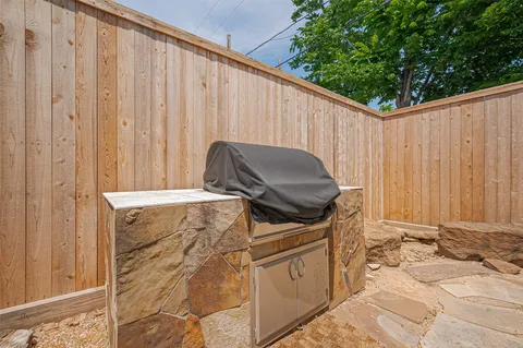 a backyard of a house with barbeque oven