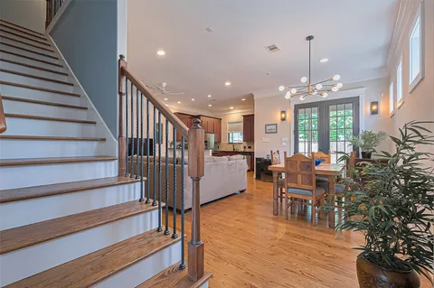 a dining room with furniture entryway and wooden floor