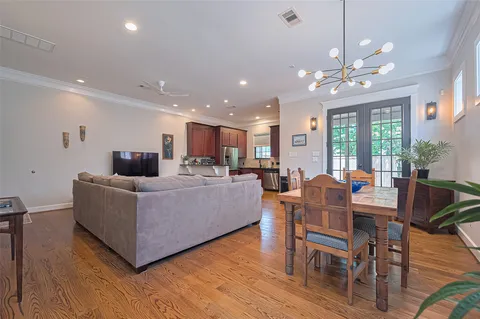 a living room with furniture kitchen and a chandelier