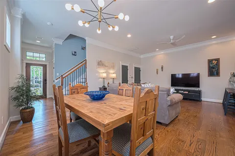 a view of a dining room with furniture and a flat screen tv