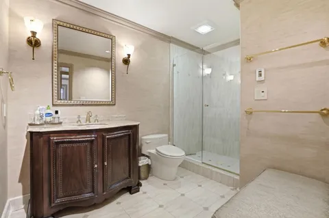 a bathroom with a toilet sink and shower