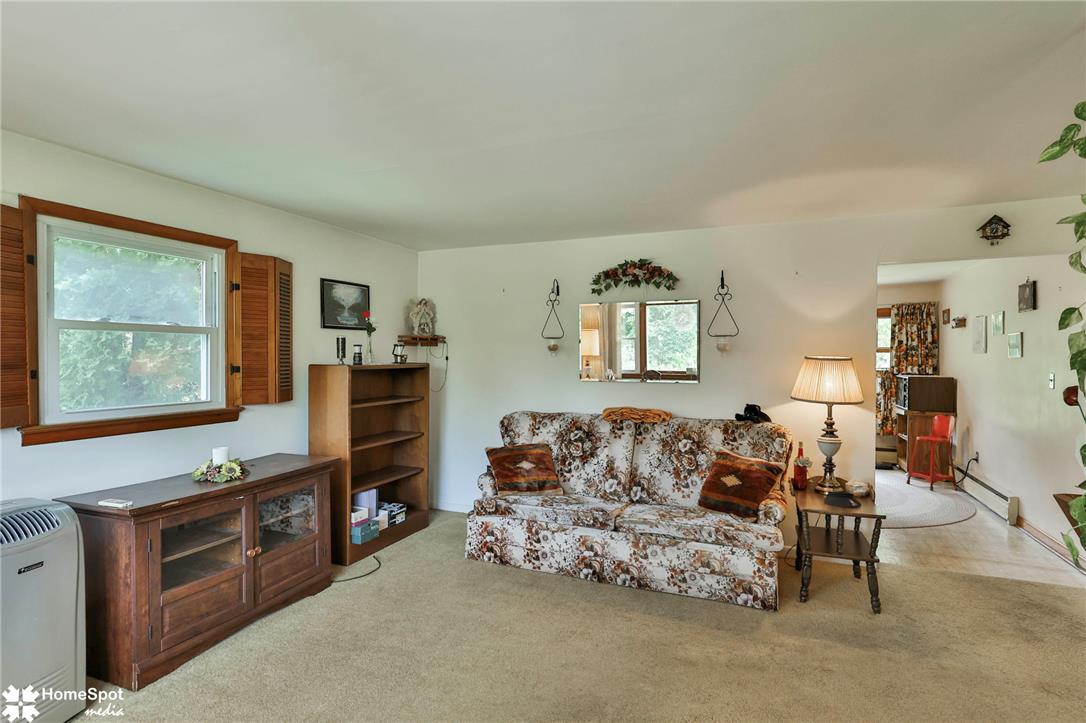 6054 Old Hickory Road Coopersburg, PA 18036 - Photo 19 of 48 Natural light pours through wood-framed windows into this welcoming living area featuring neutral carpet.