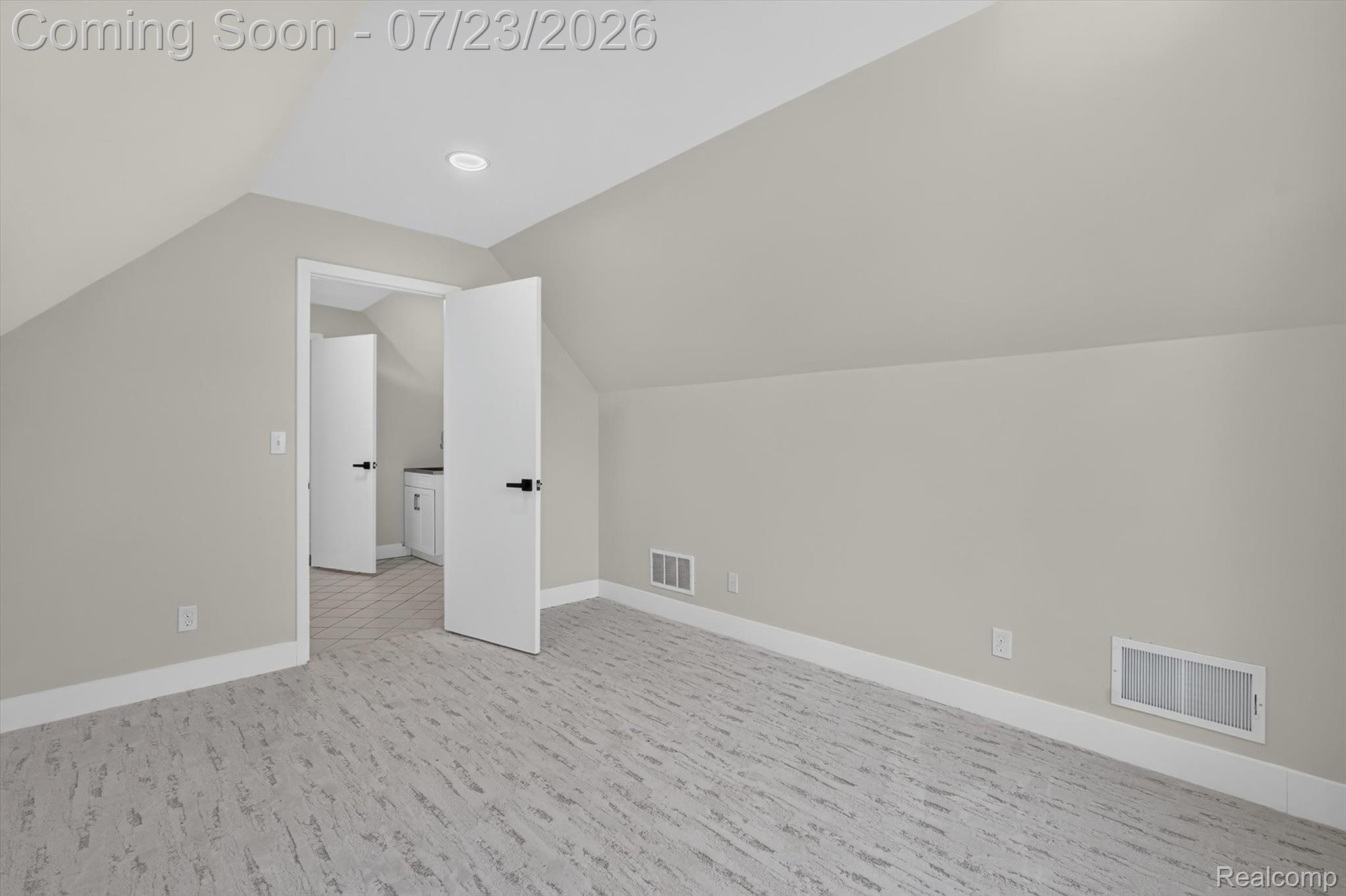 3429 Rolston Road Fenton, MI 48430 - Photo 31 of 62 Spacious room featuring sloped ceilings, recessed lighting, and patterned carpeting