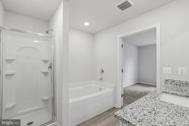 a bathroom with a bathtub and a shower