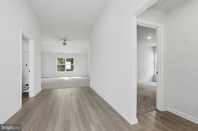 a view of hallway with wooden floor