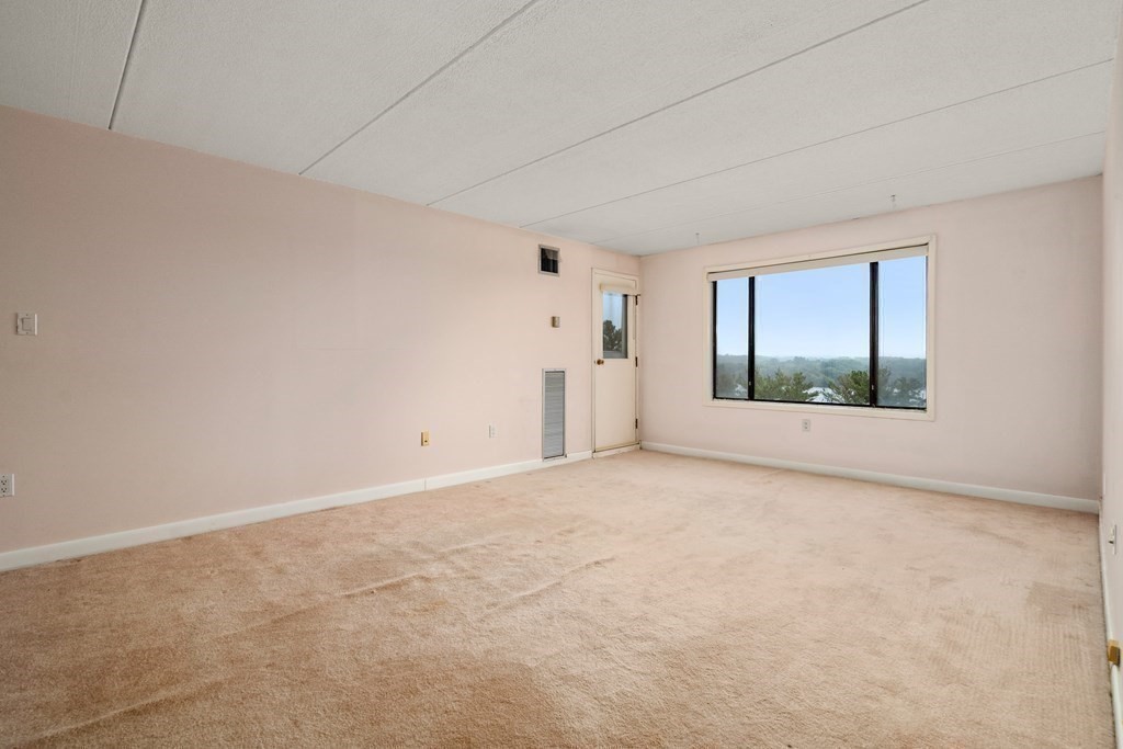 1550 Worcester Road, Unit 402 Framingham, MA 01702 - Photo 15 of 32 a view of an empty room with windows