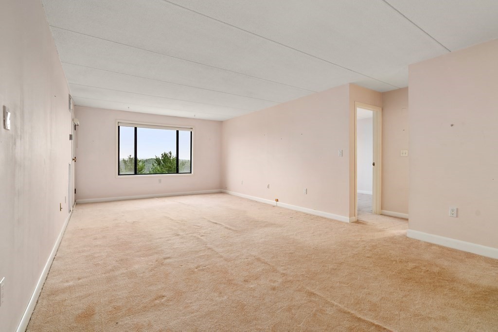 1550 Worcester Road, Unit 402 Framingham, MA 01702 - Photo 16 of 32 an empty room with windows and closet